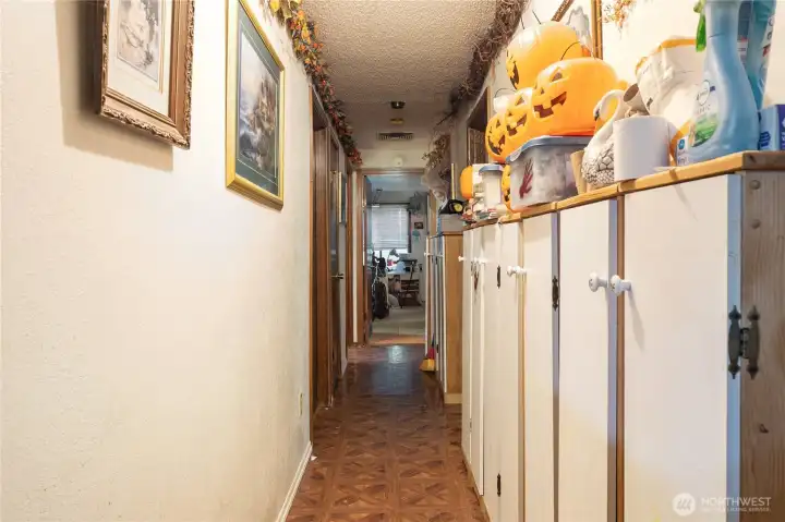 Hallway to the bedrooms, primary bedroom straight ahead.  One bedroom to the left and one to the right.
