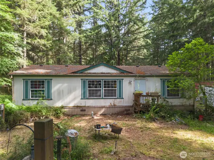 Manufactured home on the land - not attached, conveys as personal property.