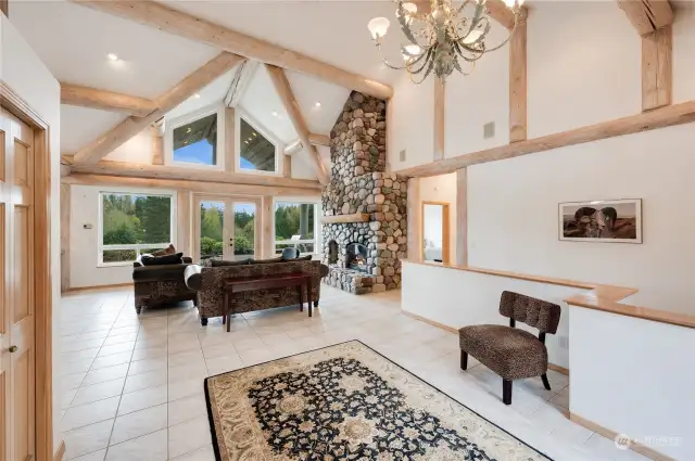 You will not believe the natural light in this home! Soaring ceilings and gorgeous log accents, river rock fireplace and floor to ceiling windows. This home is stunning!