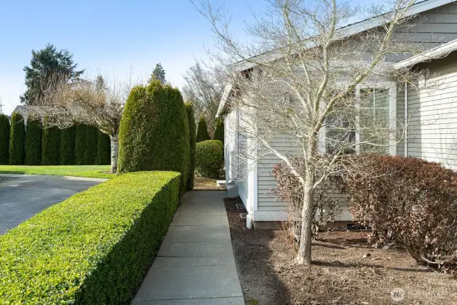 Beautifully landscaped, paved walkway to front door.