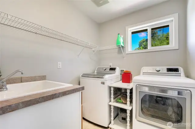 Upstairs laundry area with deep sink.