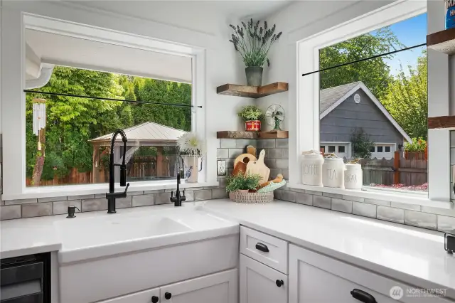 Farm sink and large kitchen windows, perfect for looking at your beautiful private outdoor space.