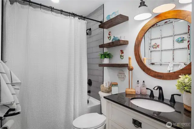 Full bath with beautifully tiled shower and quart countertops.