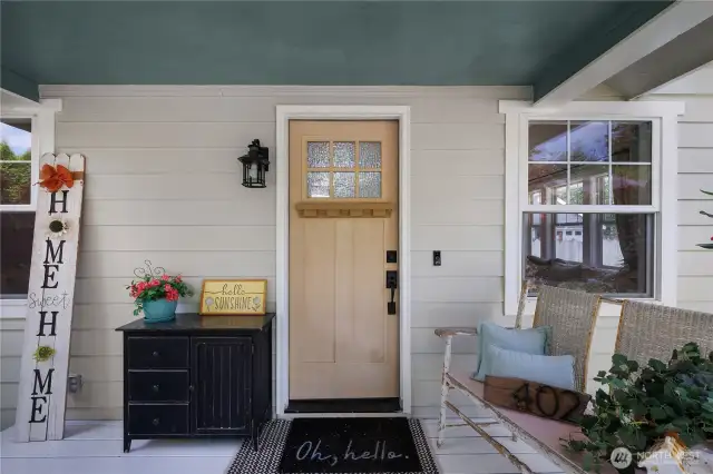 Sweet covered porch and new door ready for you to paint it your favorite color.