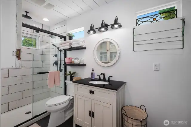 Another view of the bathroom, with shiplap ceilings and thoughtfully placed windows.