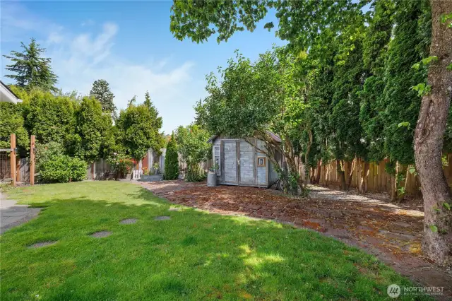 Plenty of privacy trees and a garden shed for all of your supplies.