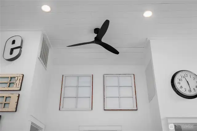 Beautiful high ceiling with ceiling fan.  Notice the windows on the wall are from the original home.