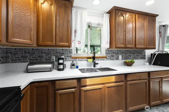 Kitchen window above sink over looking the landscaped backyard
