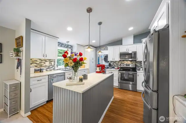 Quartz countertops, vinyl plank flooring, Stainless Whirlpool appliances