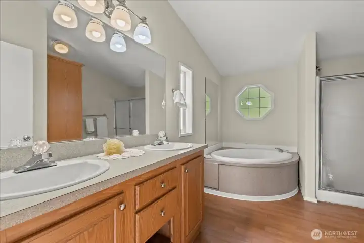 Bathroom is complete with double sinks, a soaking tub and a shower and toilet!