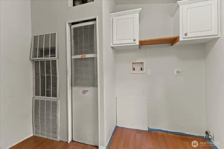 Utility room is off the kitchen and has a door to the back yard.