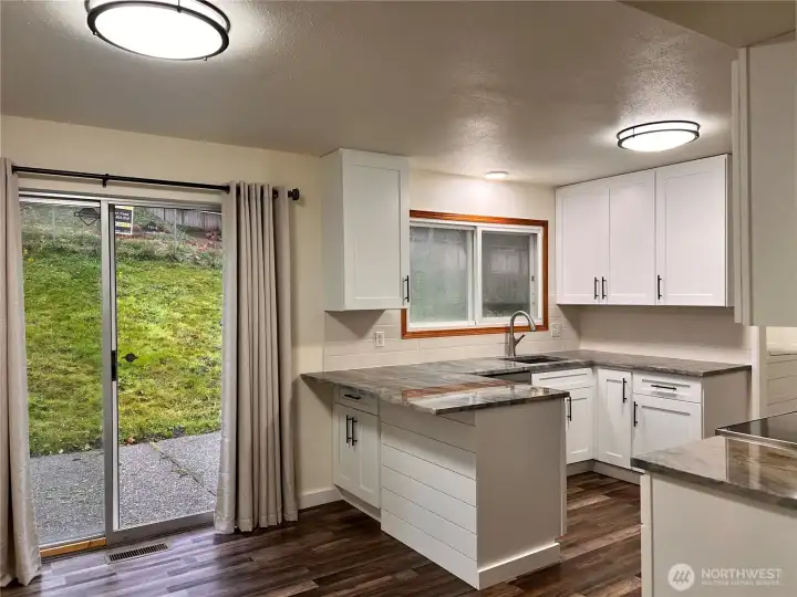 Kitchen and nook with sliding glass door to rear yard