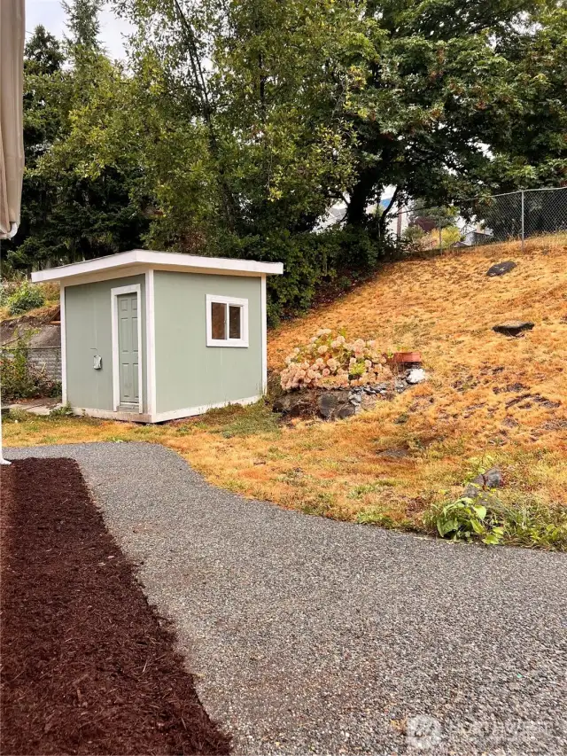 Rear yard fully fenced with garden shed.
