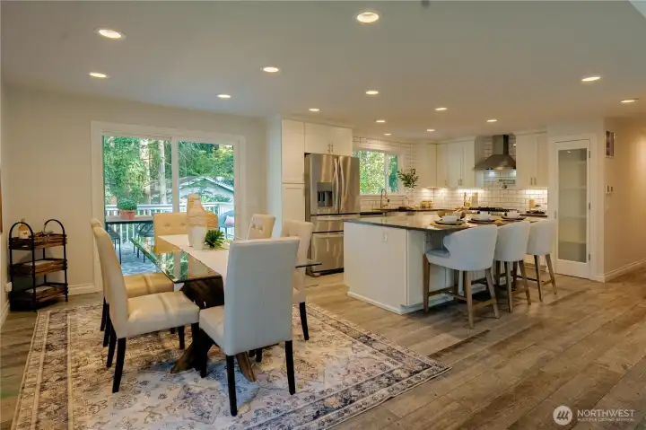 Elegant great room with dining area and kitchen with oversize island and bar seating.