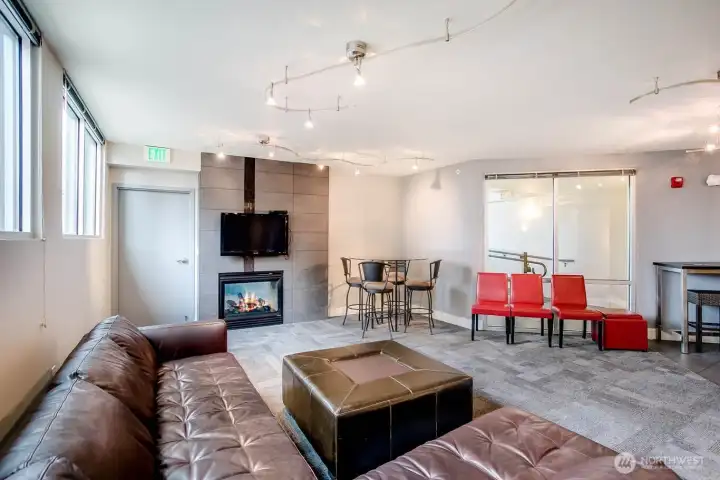 Community room with pool table, fireplace, kitchen prep area