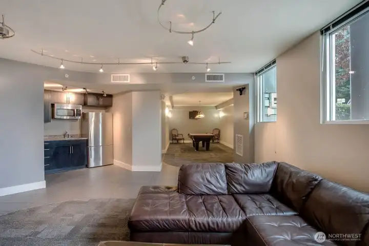 Community room with pool table, fireplace, kitchen prep area