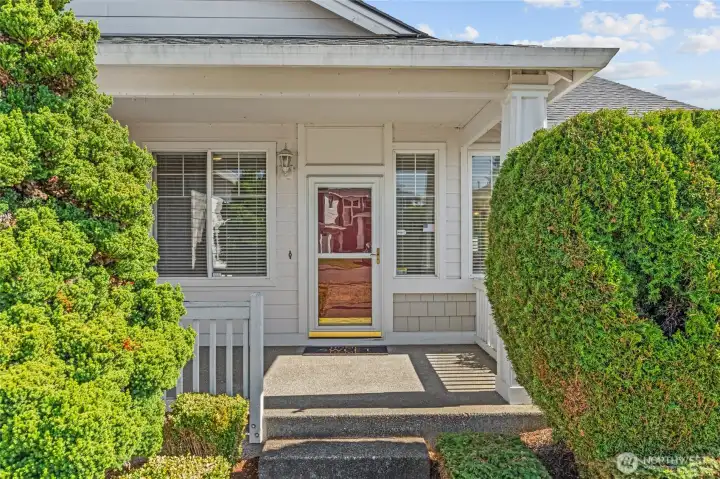 Welcoming covered front entry with spacious porch.  Lots of windows and full-paned storm door offers lots of northwestern facing afternoon natural light.
