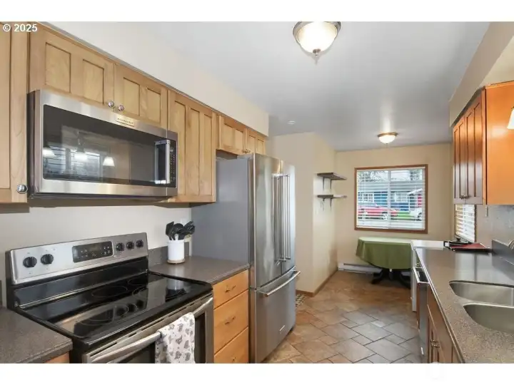 Stainless steel oven, built in microwave, refrigerator, and dishwasher.