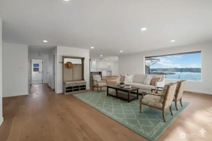 Virtually staged great room with minimal furniture.