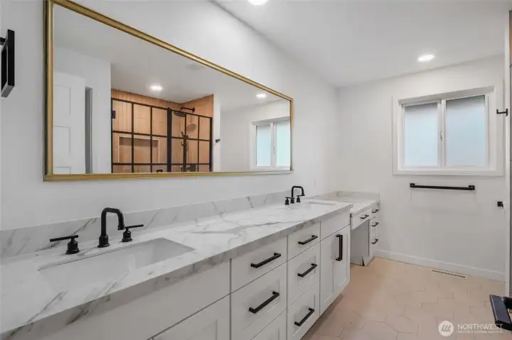 This beautifully remodeled third bathroom showcases a dual vanity, designer finishes, and a high-end shower for an elevated everyday experience!  Nothing but the best for YOU!