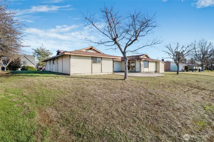 When spring comes, enjoy the back patio, and when the trees begin to leaf out, and the grass seeds sprout, you'll have a nice amount of shade in this backyard that flows gently to the lake.