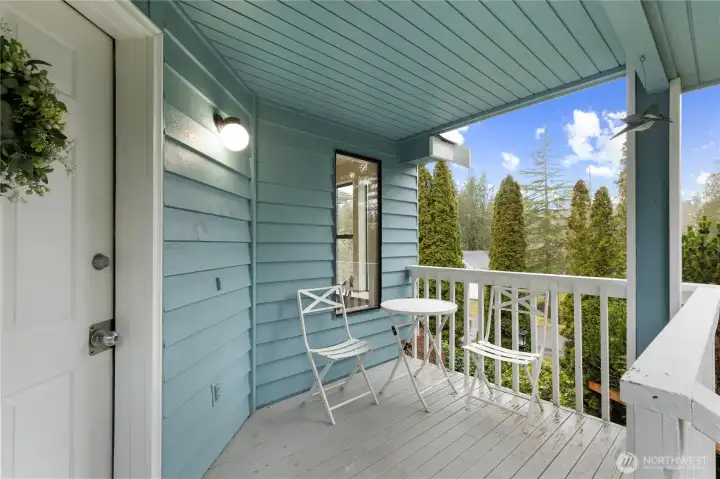 Front door entrance with a small deck/porch.