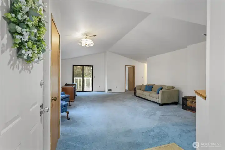 Enter into a very spacious main living room with a vaulted ceiling. The entire interior of this home has been freshly painted.