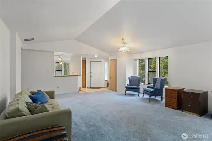 Front door entrance with a coat closet to the upper right. Plenty of room for a large sectional and a few chairs.