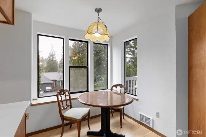Casual dining space in front of the windows.