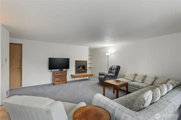 The 2nd living room has a wood burning fireplace. The door on the left is the staircase leading down to the garage.