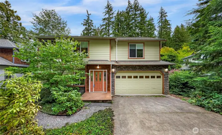 Welcoming two-story home with attached garage, mature landscaping & level driveway access. Low-maintenance yard makes it easy to enjoy the peaceful wooded surroundings without a lot of upkeep.