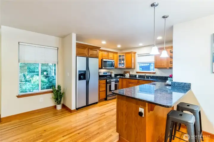 Well-designed kitchen with stainless steel appliances, generous cabinet storage, and peninsula seating that opens to the main living area—ideal for casual dining and gathering.