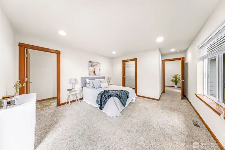 Generous primary bedroom offers plenty of space for a sitting area, with a walk-in closet and private en-suite bathroom nearby for everyday comfort.