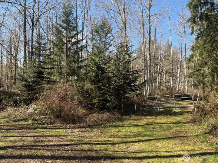 Gated entry to property. Survey marker for property to right to the gate.