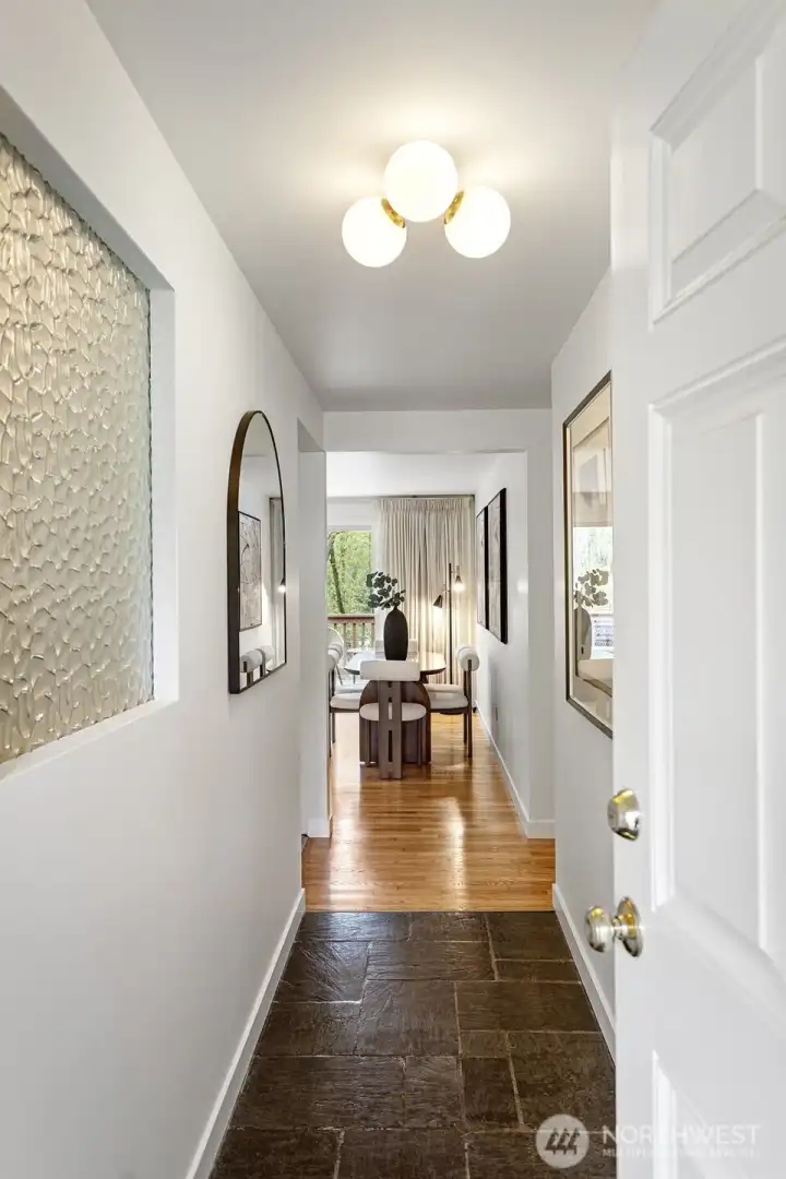 Entry features new light and original slate floors. New baseboard trim and paint!