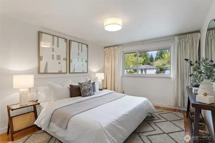 Lovely primary bedroom. Refinished oak hardwoods, fresh paint and baseboards. New overhead light.