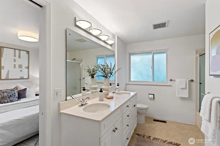 Large main floor bath with double vanity.