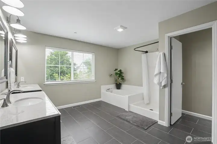 Primary Ensuite with garden tub, walk-in shower, and toilet room