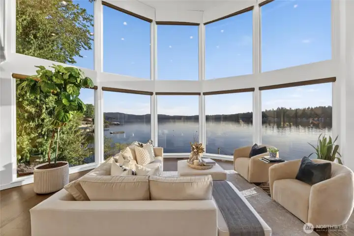 There are views, and then there is this. The curved glass great room wraps you in an uninterrupted panorama of open water — no matter where you sit, the lake is always the centerpiece.