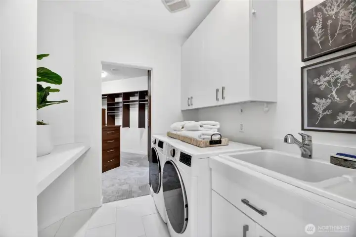 Thoughtfully placed just off the primary closet, this crisp, well-appointed laundry room makes the everyday effortless.