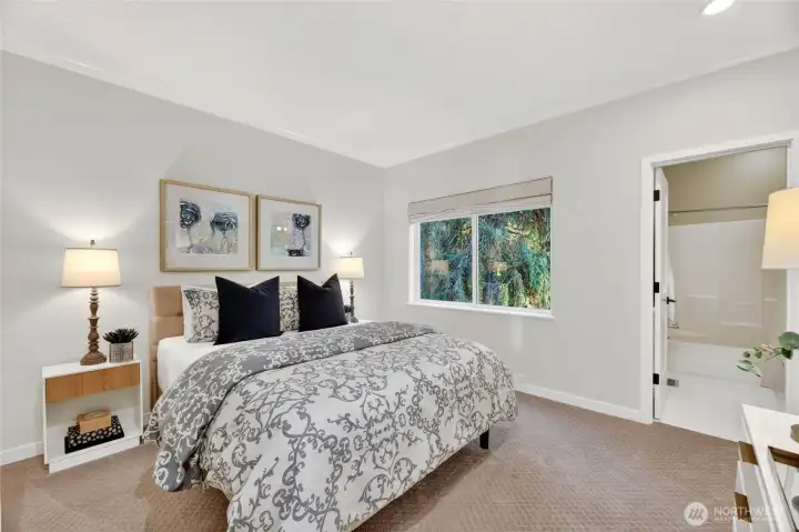 A quiet, generously sized bedroom on the main floor with its own en-suite bath. A comfortable, private space with a view.