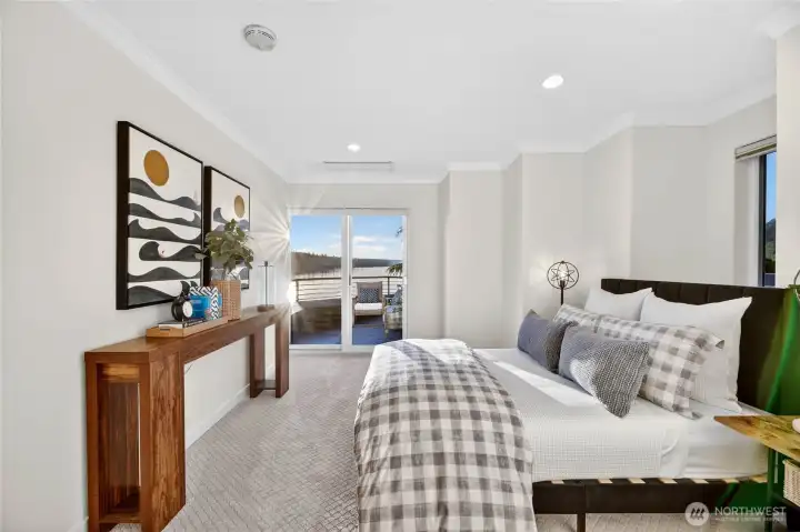 Cool, calm, and completely lake-facing — this upper level bedroom opens directly to a relaxing rooftop deck.