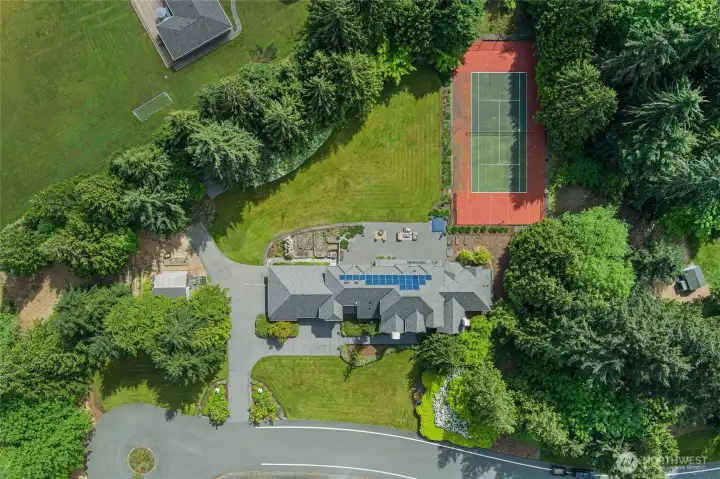 Private setting with abundant natural light. Sport Court with basketball and tennis.