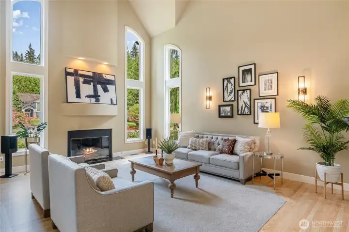 Elegant formal living room with soaring ceilings and gas fireplace