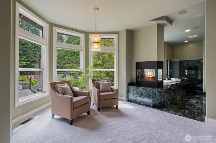 Main Floor Primary Bedroom Sitting area looking out at the beautiful back yard nature and gardens.