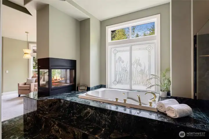 Wind down in this jetted soaking tub with gas fireplace.