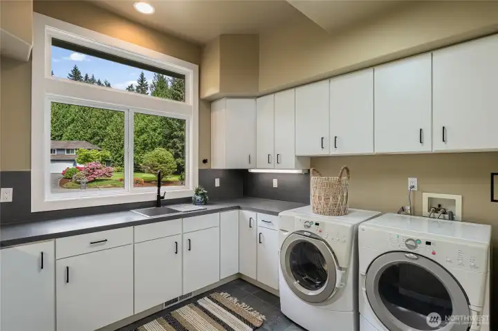 Large main floor laundry room with plenty of space and storage