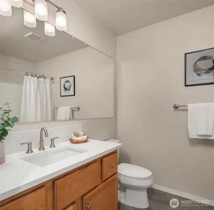 Main floor, full bath with new counters, lighting, and Koehler fixtures.