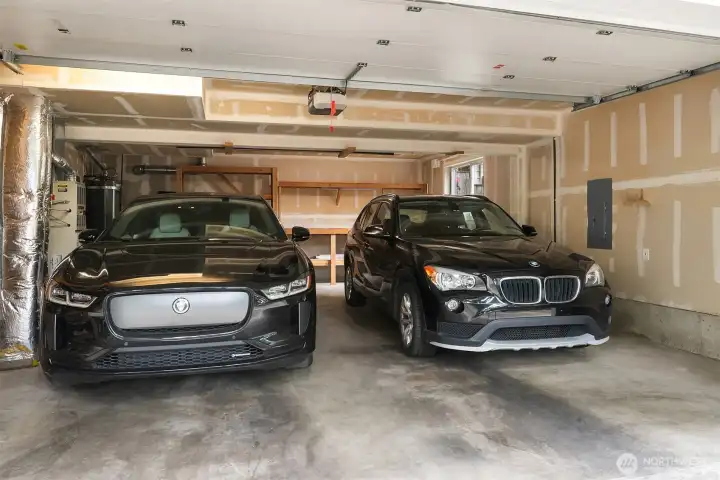 Two car, large garage, with storage shelves and workbench for the craftsman.