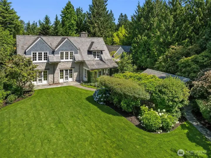 Classic home exterior framed by lush, mature landscaping. Classic home exterior framed by lush, mature landscaping.